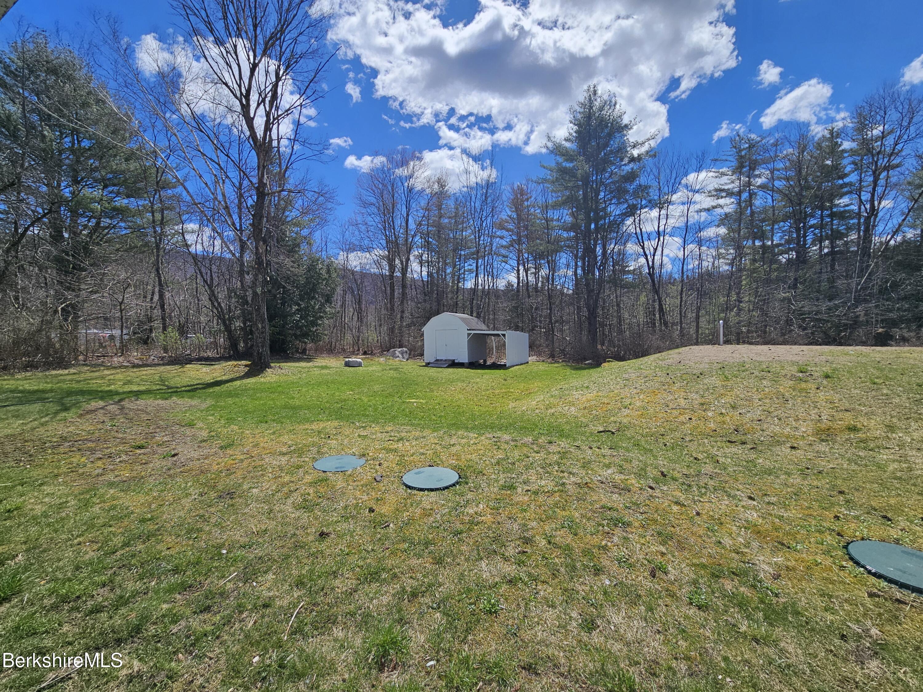 1130 Middle Road Clarksburg, MA 01247 - Photo 6 of 28 a view of a field with a house in the background