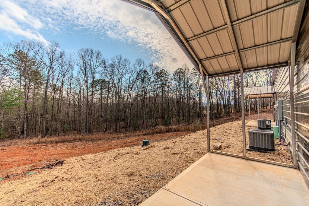 137 A Johnson Ford Road Epworth, GA 30541 - Photo 20 of 21 a backyard of a house with lots of green space and wooden fence
