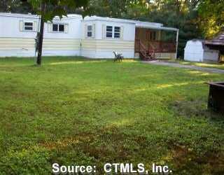 a front view of house with yard and seating area