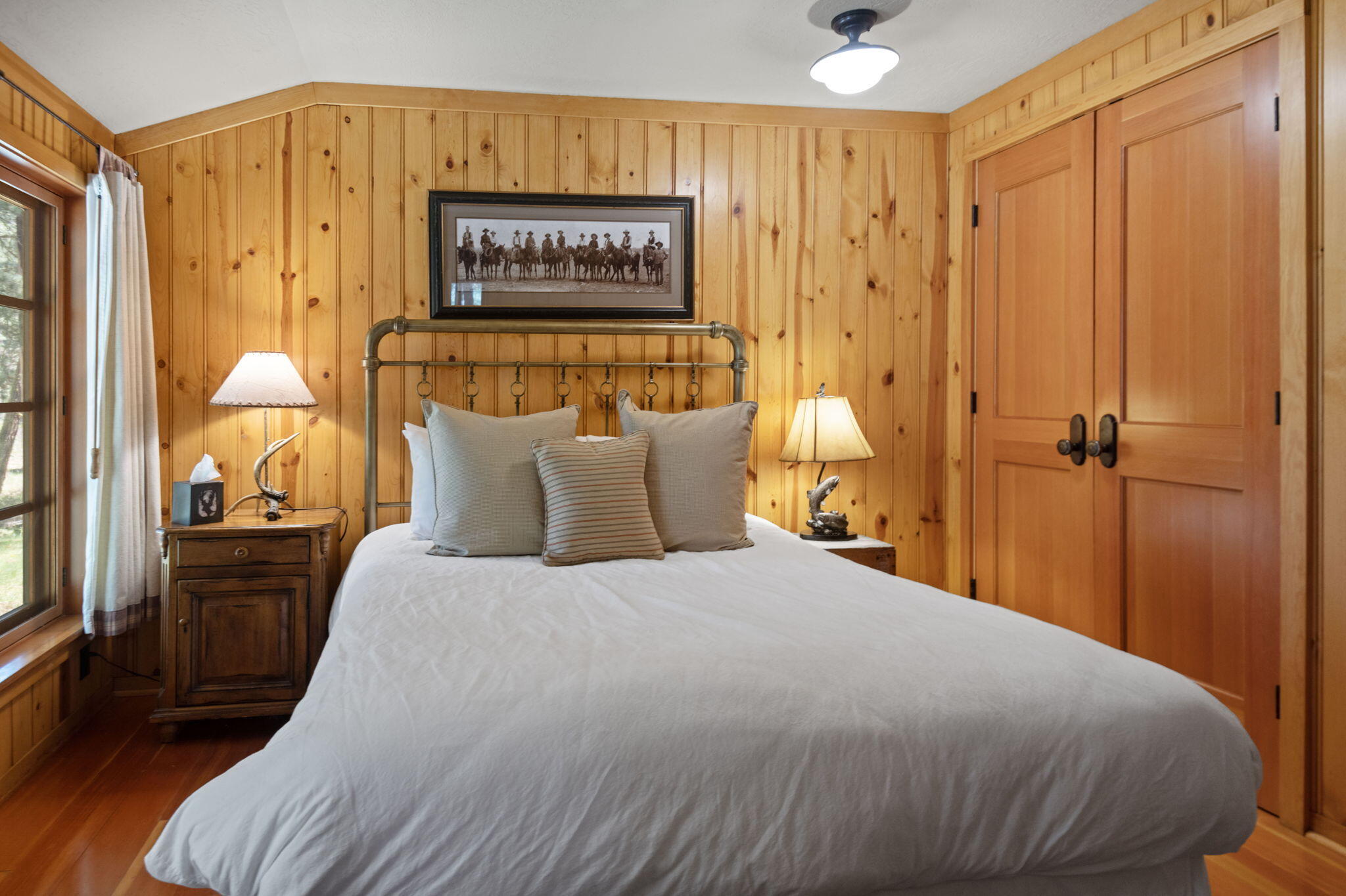 13375 Southwest Forest Service Road, Unit CABIN 18 U1 Camp Sherman, OR 97730 - Photo 11 of 31 a bedroom with a bed and a chandelier