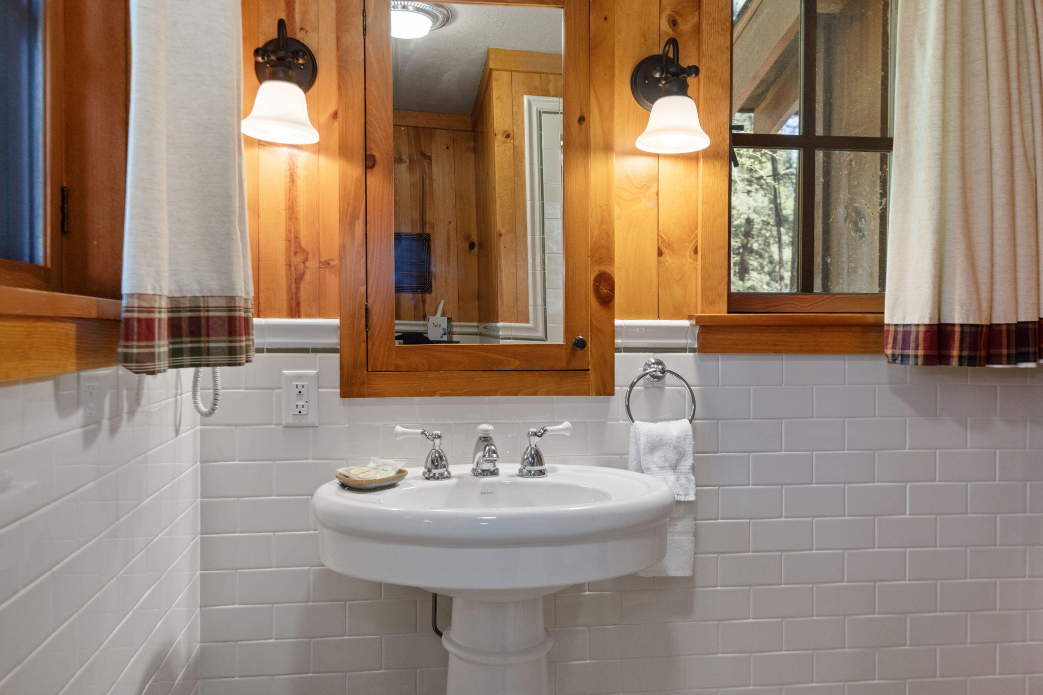 13375 Southwest Forest Service Road, Unit CABIN 18 U1 Camp Sherman, OR 97730 - Photo 17 of 31 a bathroom with a sink and a mirror