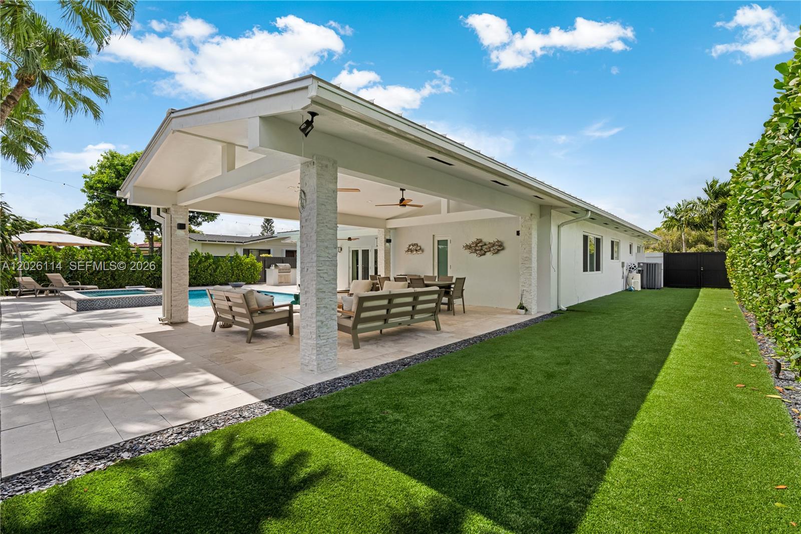 9641 Southwest 66th Street Miami, FL 33173 - Photo 36 of 57 a view of a patio with table and chairs under an umbrella