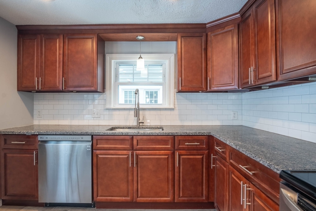 509 Plumtree Road Springfield, MA 01118 - Photo 12 of 34 a kitchen with granite countertop wooden cabinets