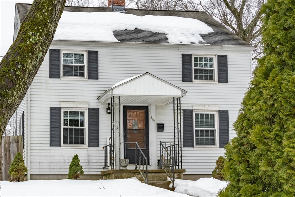 509 Plumtree Road Springfield, MA 01118 - Photo 2 of 34 a view of a white house with large windows and a small yard