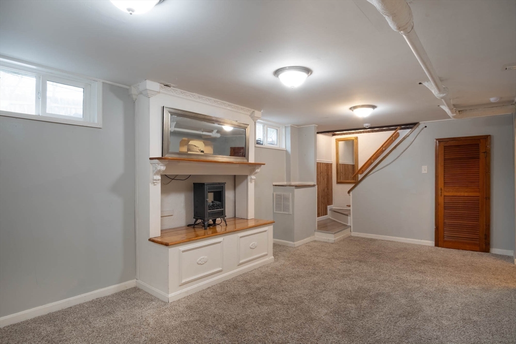 509 Plumtree Road Springfield, MA 01118 - Photo 24 of 34 a room with fireplace and stairs