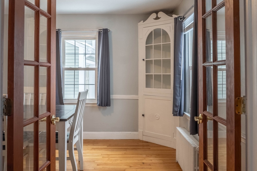 509 Plumtree Road Springfield, MA 01118 - Photo 7 of 34 a view of an empty room with a window and wooden floor