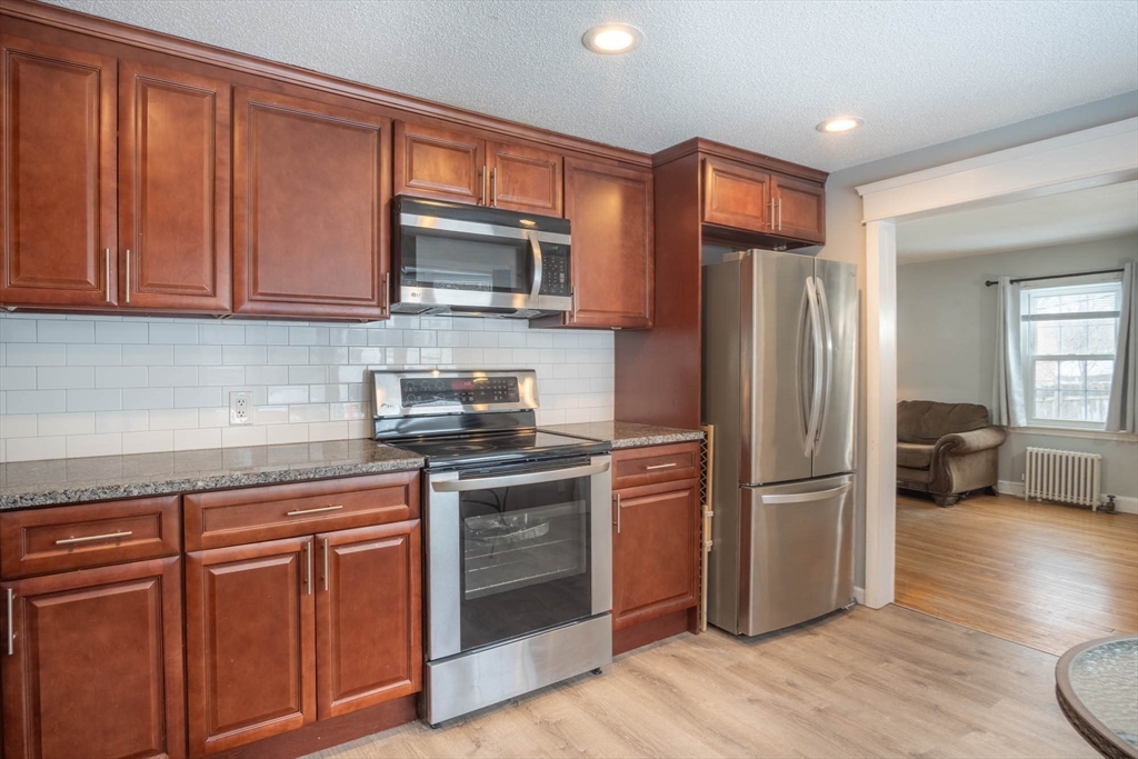 509 Plumtree Road Springfield, MA 01118 - Photo 10 of 34 a kitchen with stainless steel appliances granite countertop a refrigerator stove and sink