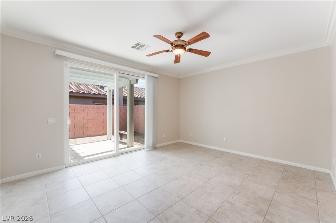 10481 Riverside Park Avenue Las Vegas, NV 89135 - Photo 20 of 51 Unfurnished room featuring ornamental molding, a ceiling fan, and light tile patterned flooring