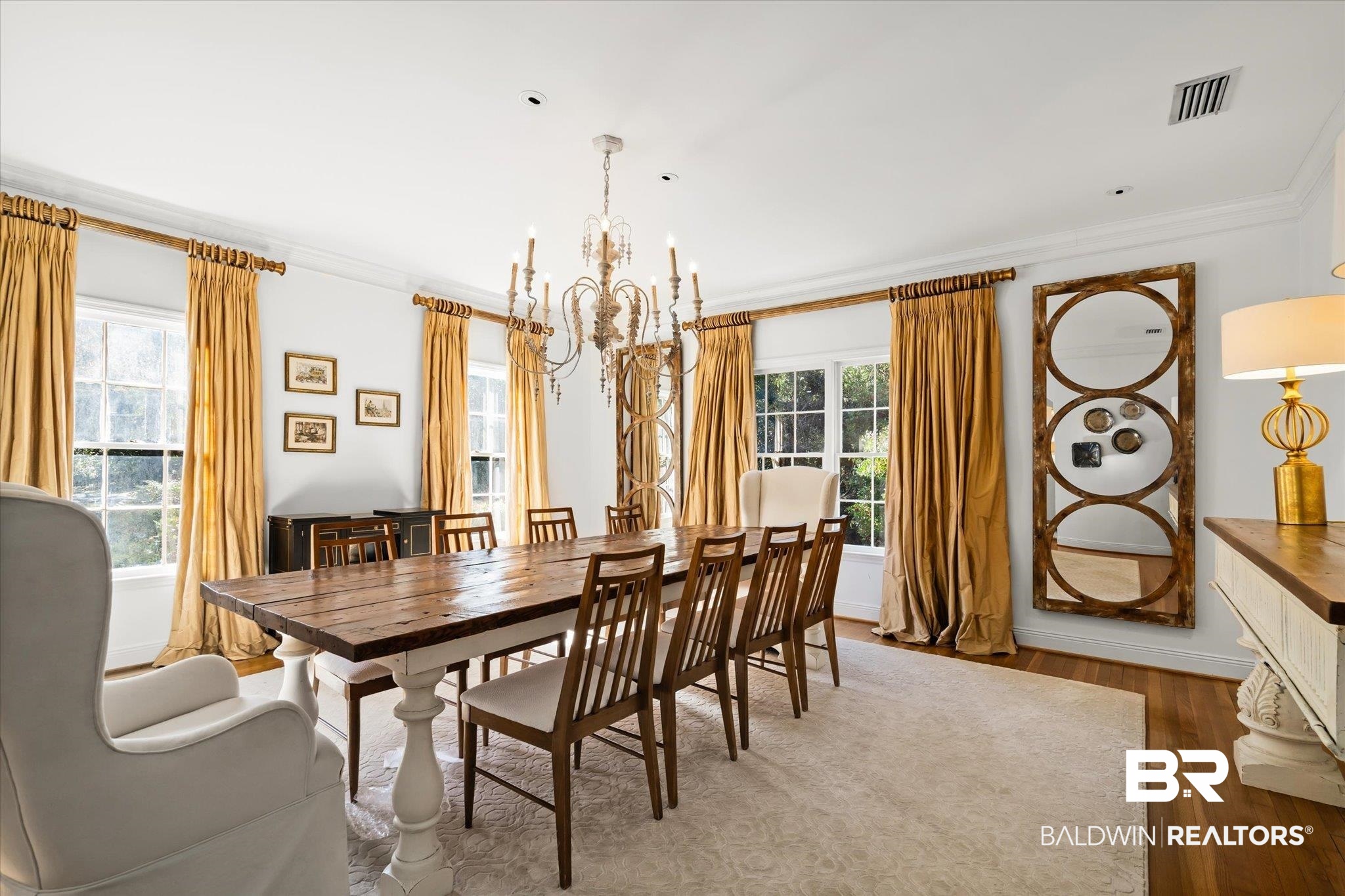 143 Myrtlewood Lane Mobile, AL 36608 - Photo 6 of 55 Dining area with an inviting chandelier, wood finished floors, crown molding, and a healthy amount of sunlight