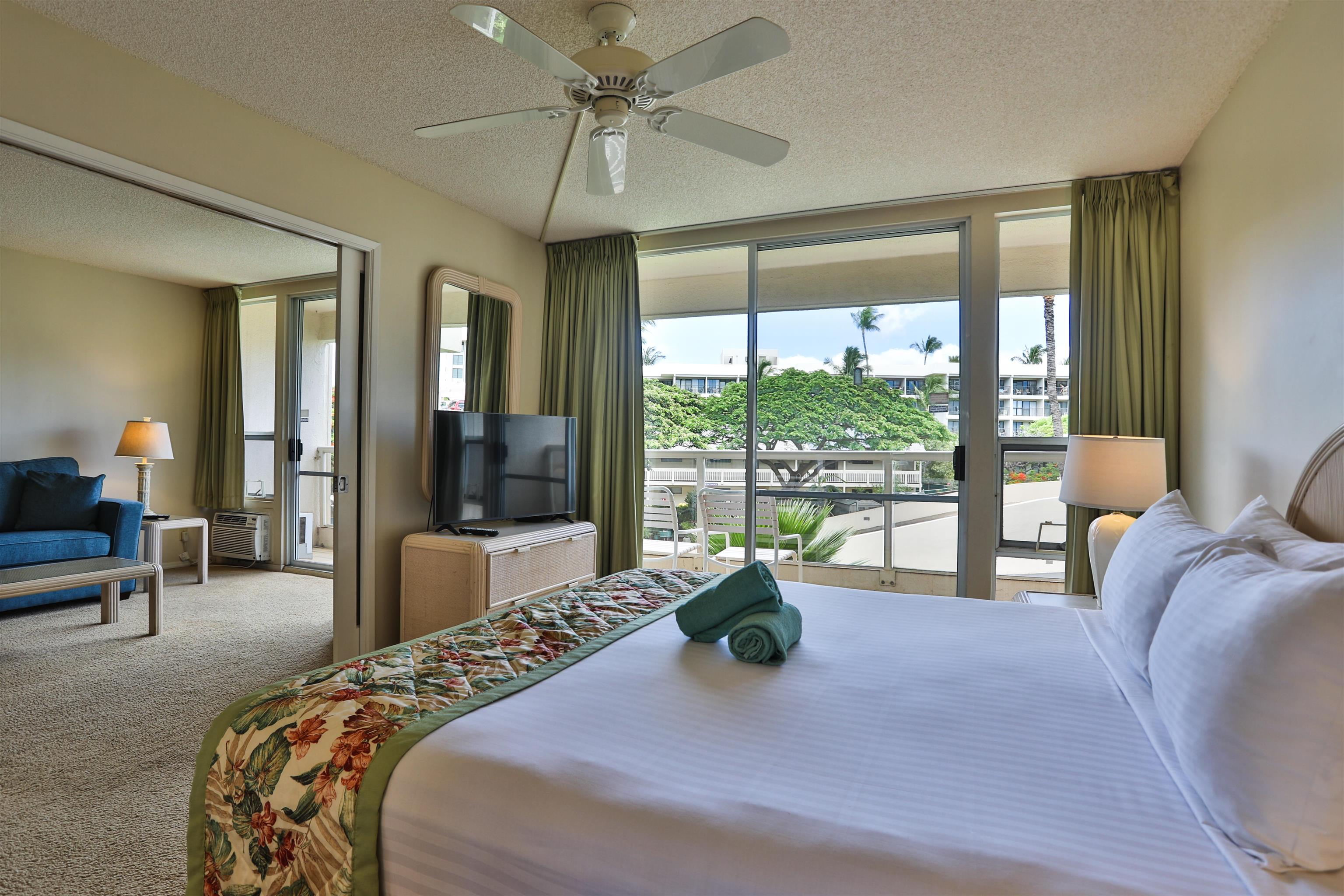2575 South Kihei Road, Unit G306 Kihei, HI 96753 - Photo 1 of 18 a bedroom with a bed and large window