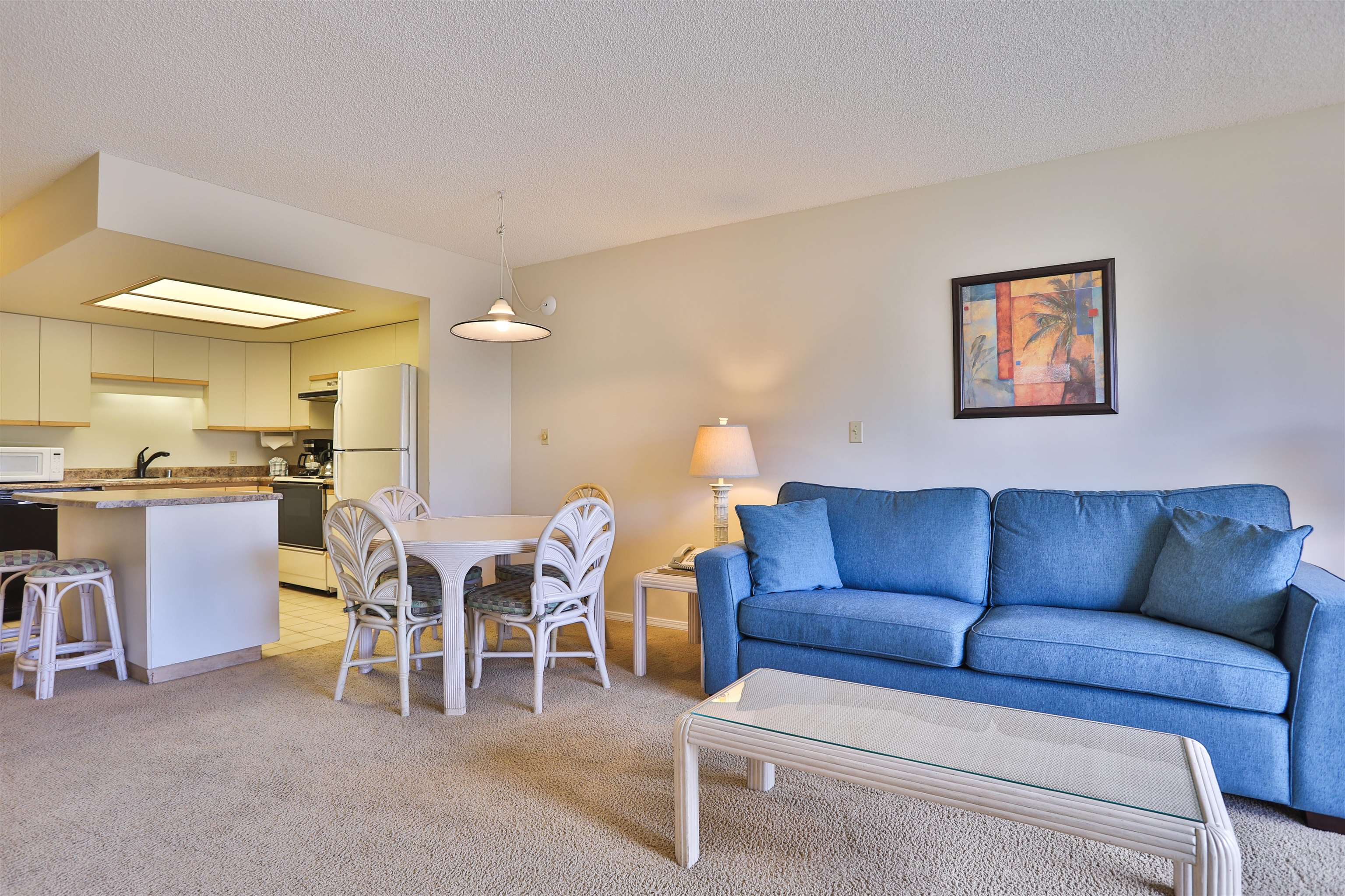 2575 South Kihei Road, Unit G306 Kihei, HI 96753 - Photo 2 of 18 a living room with furniture a dining table and a fireplace