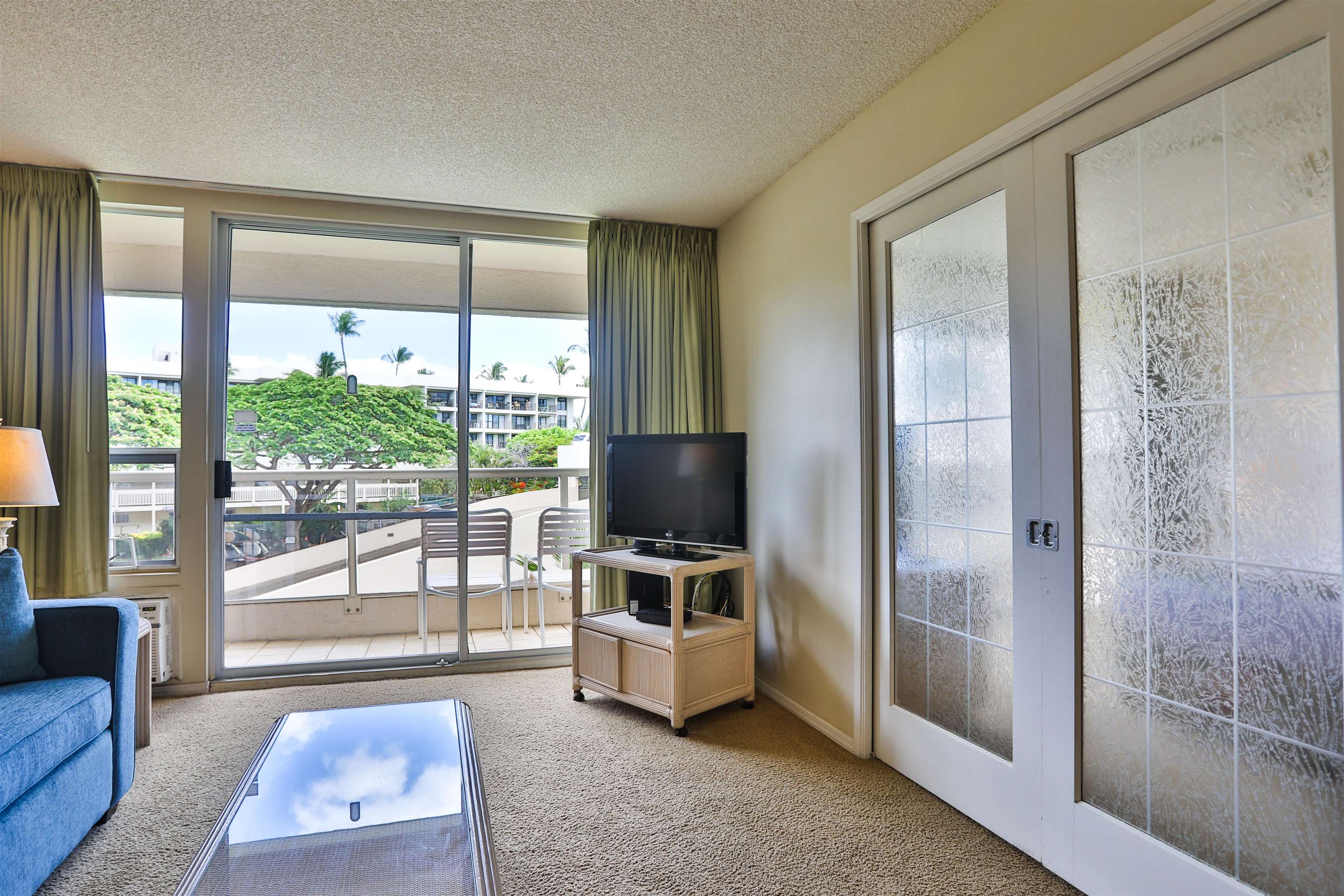 2575 South Kihei Road, Unit G306 Kihei, HI 96753 - Photo 4 of 18 a living room with glass door and furniture