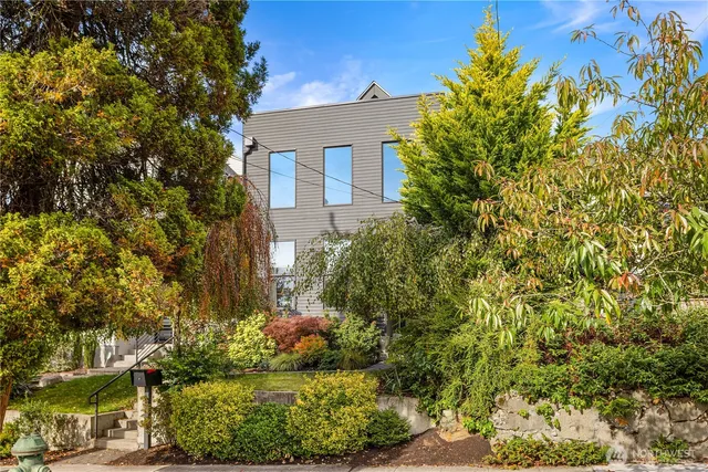 a view of a house with a yard and garden