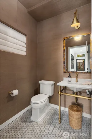 a bathroom with a sink a toilet and a mirror