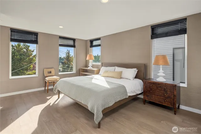 a bedroom with a large bed and a large window