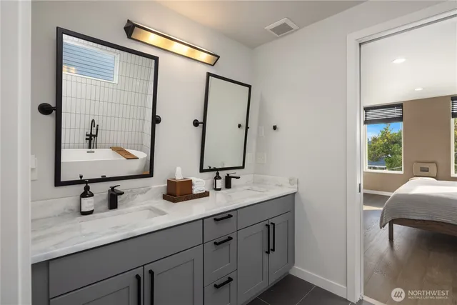 a bathroom with a double vanity sink and mirror