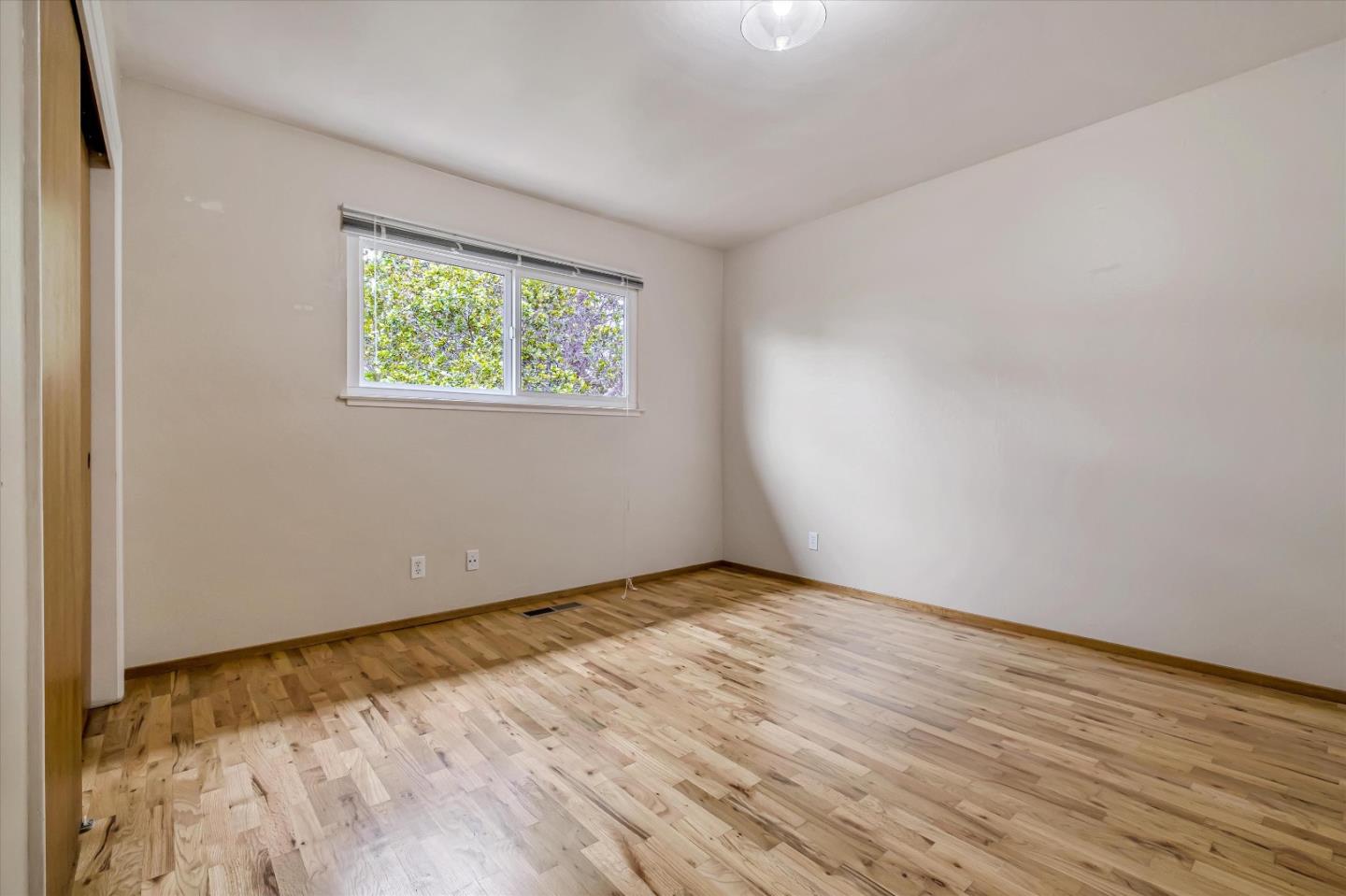 722 Seacliff Drive Aptos, CA 95003 - Photo 33 of 51 an empty room with wooden floor and windows