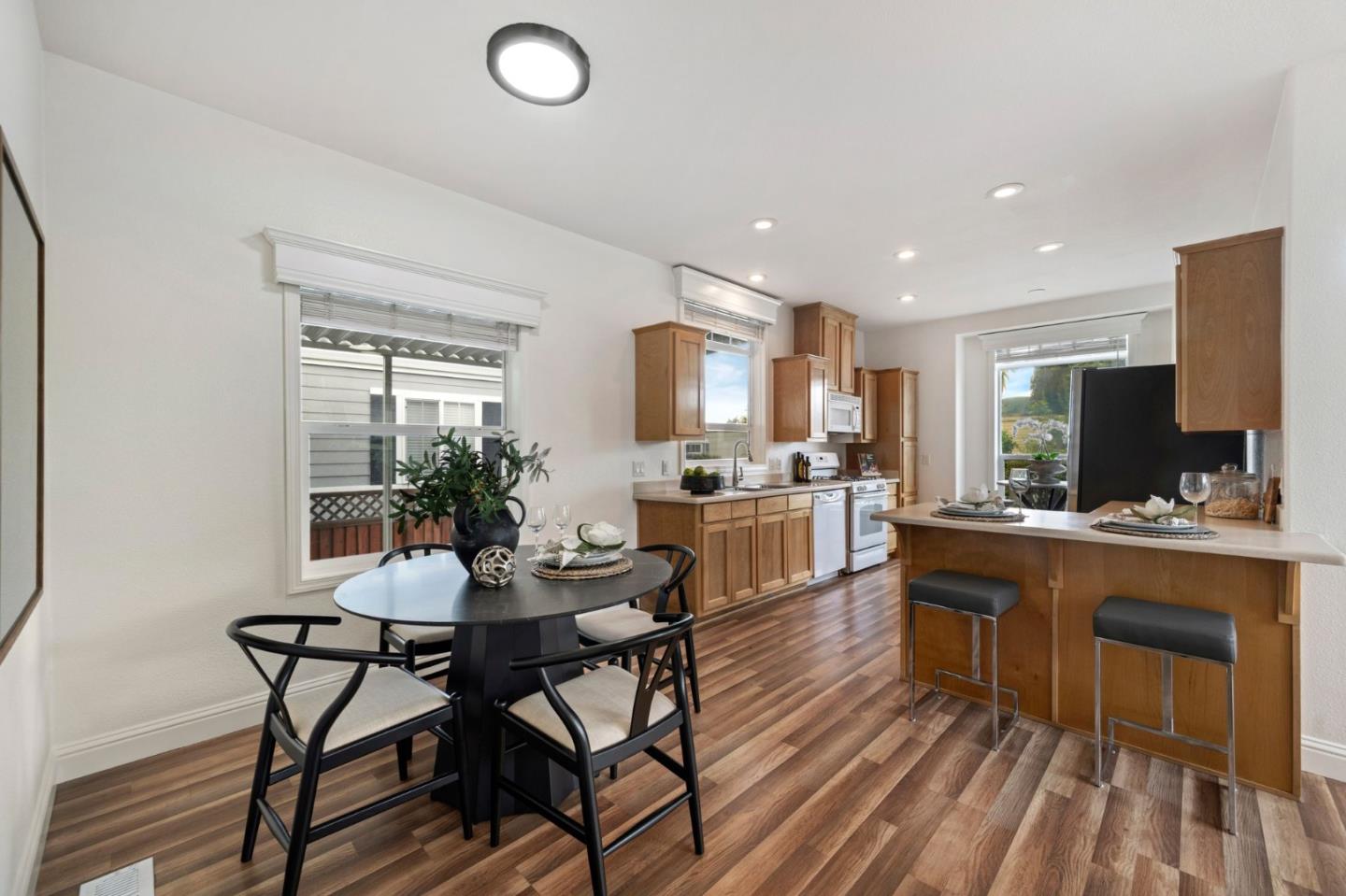 6130 Monterey Road, Unit 189 San Jose, CA 95138 - Photo 11 of 42 a kitchen with a dining table chairs and white cabinets