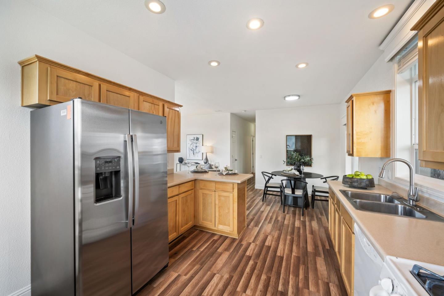 6130 Monterey Road, Unit 189 San Jose, CA 95138 - Photo 16 of 42 a kitchen with stainless steel appliances granite countertop a refrigerator a sink a stove and island with wooden floor