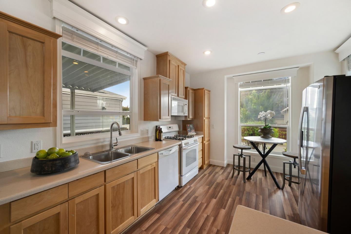 6130 Monterey Road, Unit 189 San Jose, CA 95138 - Photo 19 of 42 a kitchen with sink a refrigerator and chairs