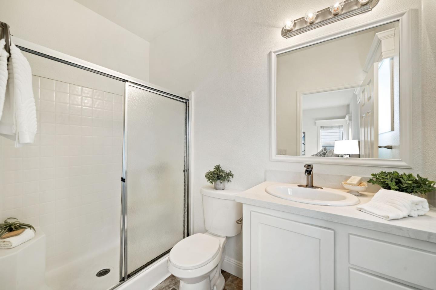 6130 Monterey Road, Unit 189 San Jose, CA 95138 - Photo 26 of 42 a bathroom with a sink a mirror a toilet and shower