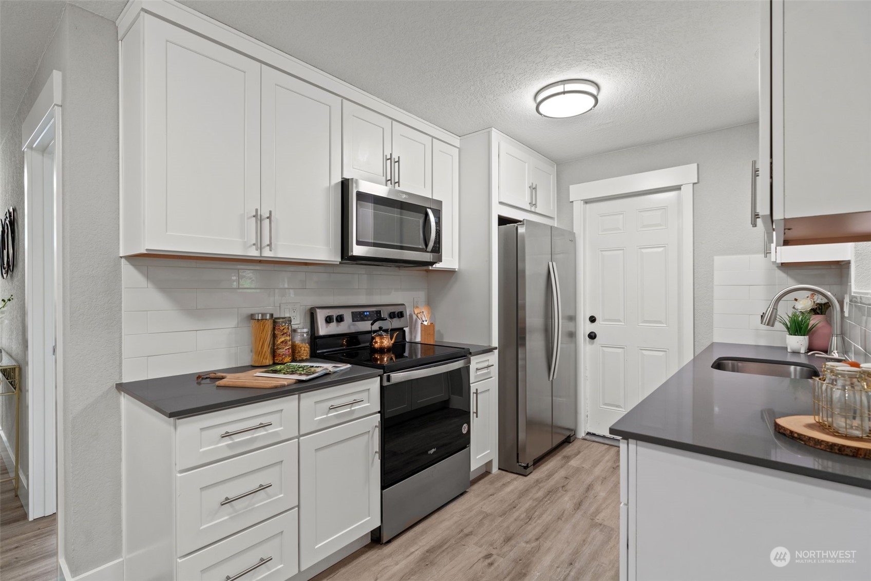 22417 18th Avenue Southeast Bothell, WA 98021 - Photo 8 of 25 a kitchen with a sink appliances and cabinets