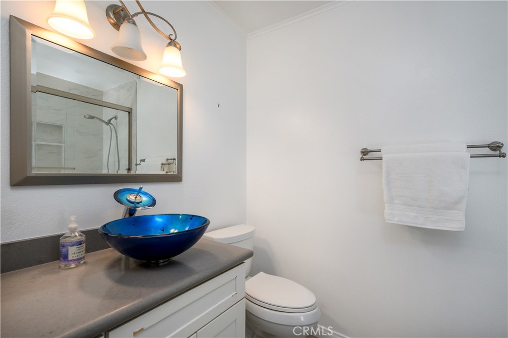 628 Daisy Avenue, Unit 222 Long Beach, CA 90802 - Photo 18 of 25 a bathroom with a toilet a sink and mirror