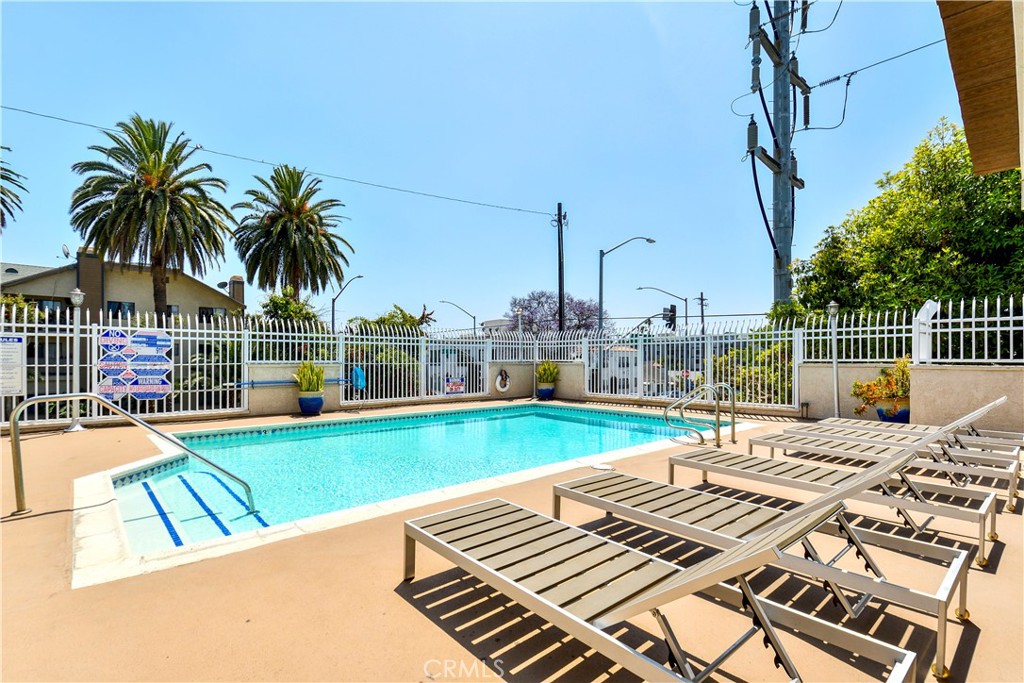 628 Daisy Avenue, Unit 222 Long Beach, CA 90802 - Photo 23 of 25 a view of a swimming pool with a lounge chairs