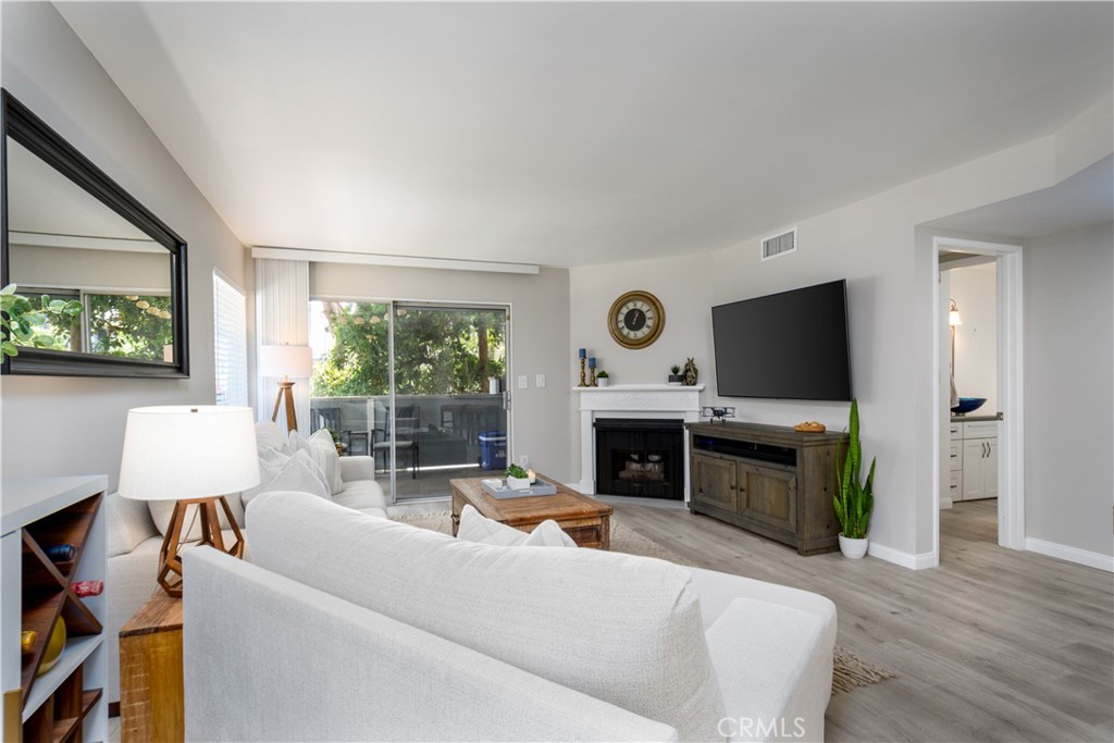 628 Daisy Avenue, Unit 222 Long Beach, CA 90802 - Photo 5 of 25 a living room with furniture a fireplace and a flat screen tv