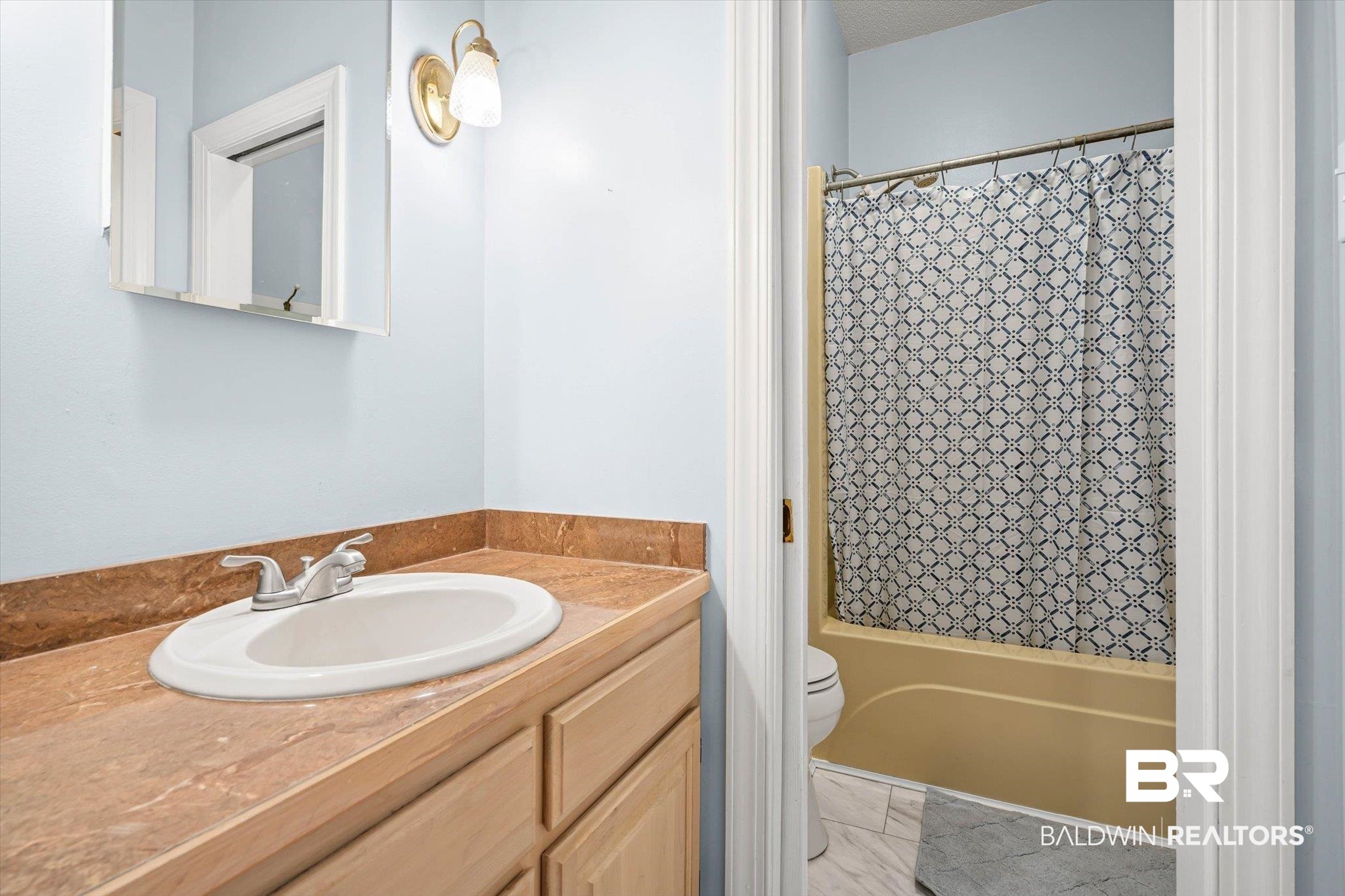 7650 Iron Rush Road Wilmer, AL 36587 - Photo 23 of 34 Bathroom featuring shower / bathtub combination with curtain and vanity