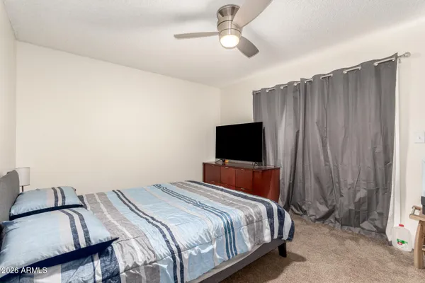 a bedroom with a bed and a flat screen tv