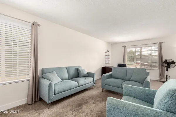 a living room with furniture and a large window