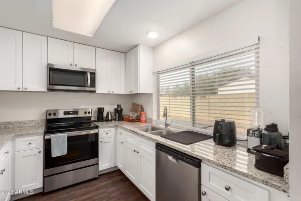 a kitchen with a sink stove and microwave