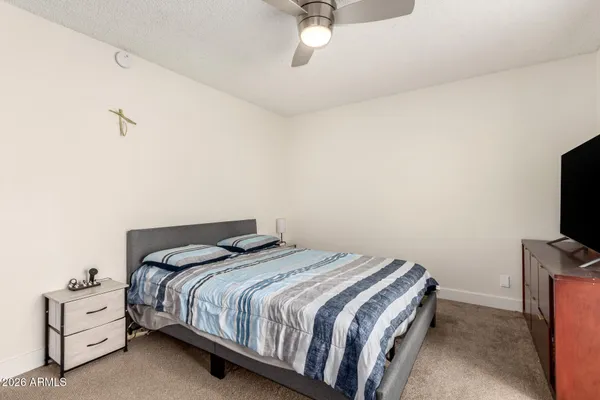 a bedroom with a bed and a flat screen tv