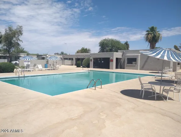 a view of a house with swimming pool and porch