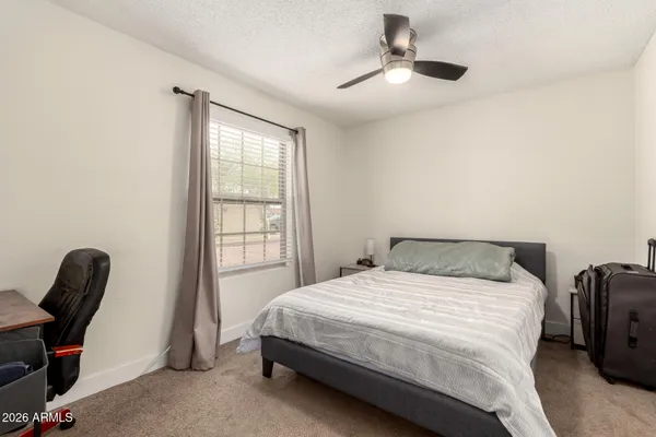 a bedroom with a bed and a chair