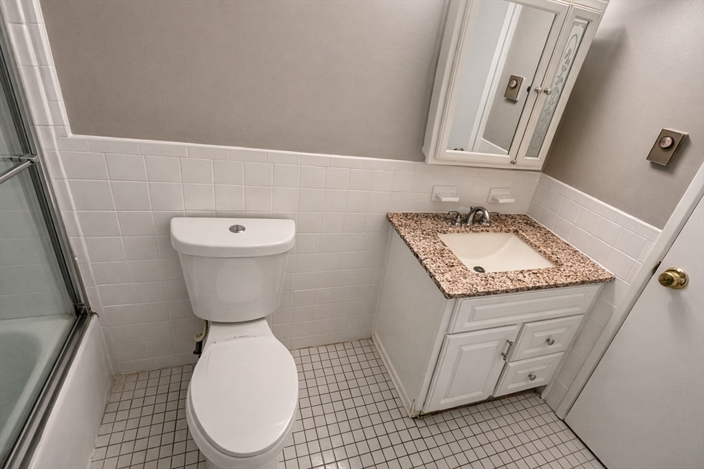 15 Weld Street, Unit 18 Framingham, MA 01702 - Photo 15 of 18 a bathroom with a toilet sink and mirror