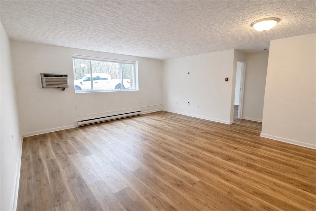 15 Weld Street, Unit 18 Framingham, MA 01702 - Photo 6 of 18 an empty room with wooden floor and windows