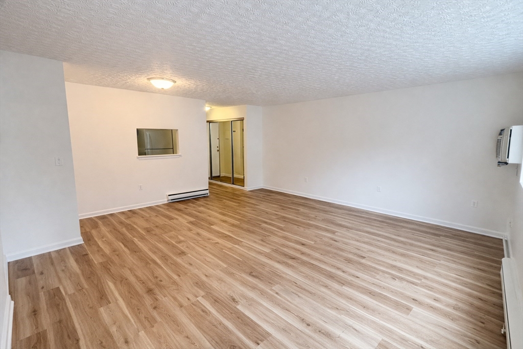 15 Weld Street, Unit 18 Framingham, MA 01702 - Photo 7 of 18 a view of an empty room with wooden floor