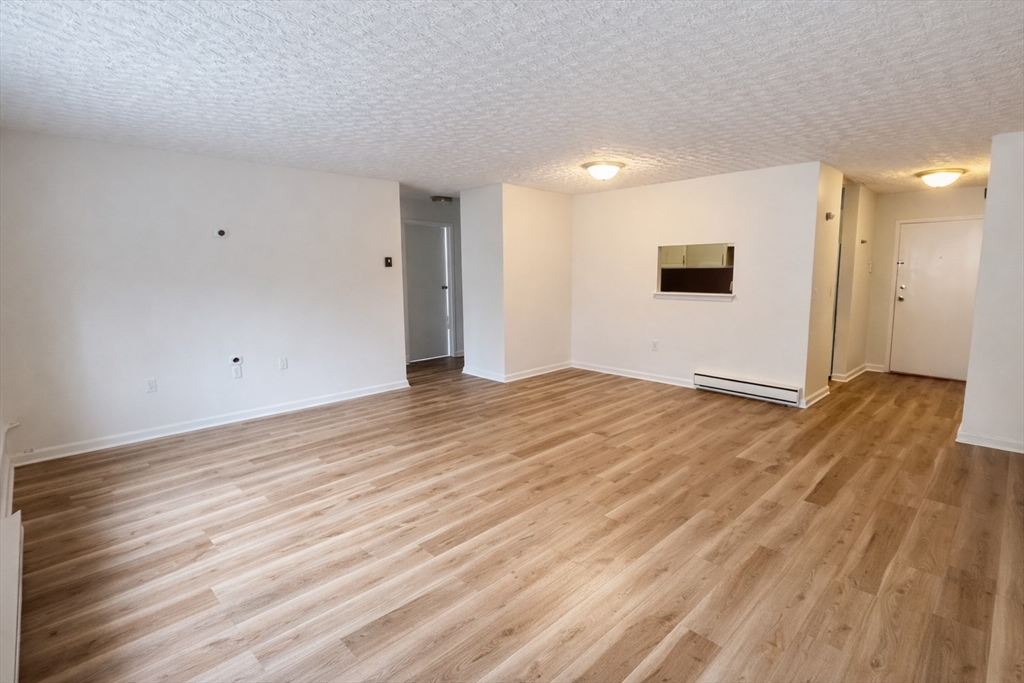 15 Weld Street, Unit 18 Framingham, MA 01702 - Photo 8 of 18 a view of a livingroom with wooden floor