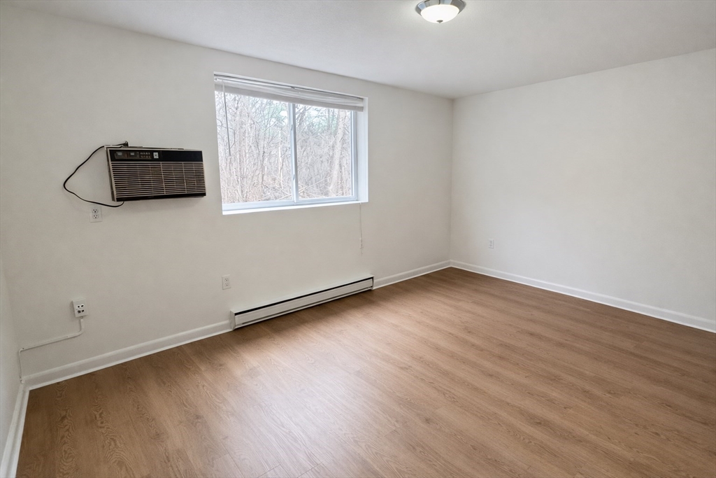15 Weld Street, Unit 18 Framingham, MA 01702 - Photo 9 of 18 an empty room with wooden floor cabinet and windows