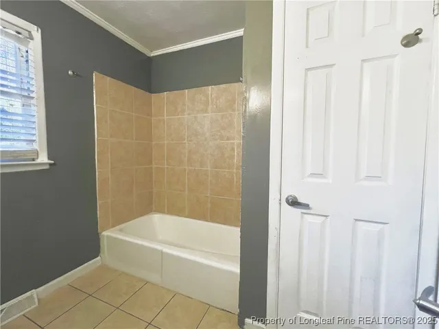 a bathroom with a bathtub and shower