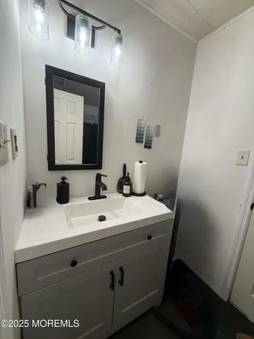 a bathroom with a sink a mirror and vanity
