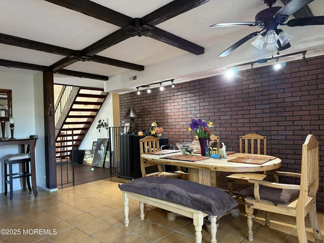a dining room with a wooden table and chairs