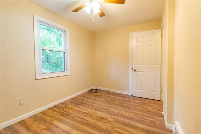 a view of a room with wooden floor and natural light