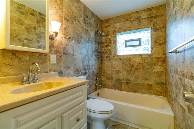 a bathroom with a sink a toilet and a bathtub