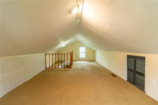 a view of hallway with stairs and a window