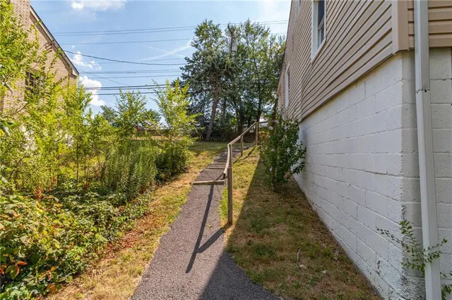 a view of a pathway of a pathway both side of house