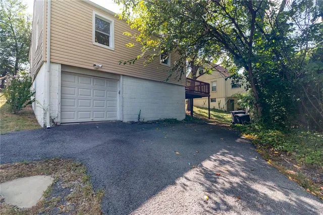 a view of a house with a yard and garage