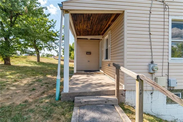 a view of house with backyard